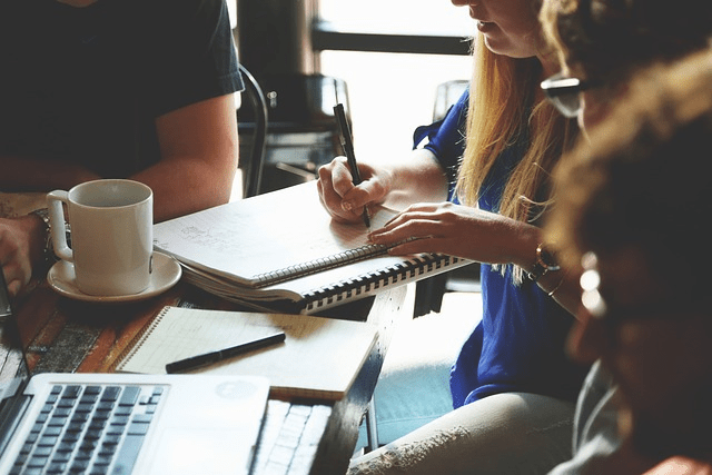 Business people discussing a comprehensive franchise marketing plan utilizing digital marketing channels and localized marketing campaignsg